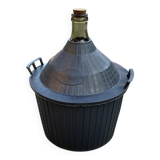 Dame-Jeanne vintage in olive green glass with a basket and black plastic lid.