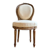 Medallion back chair in moulded wood and beige fabric.