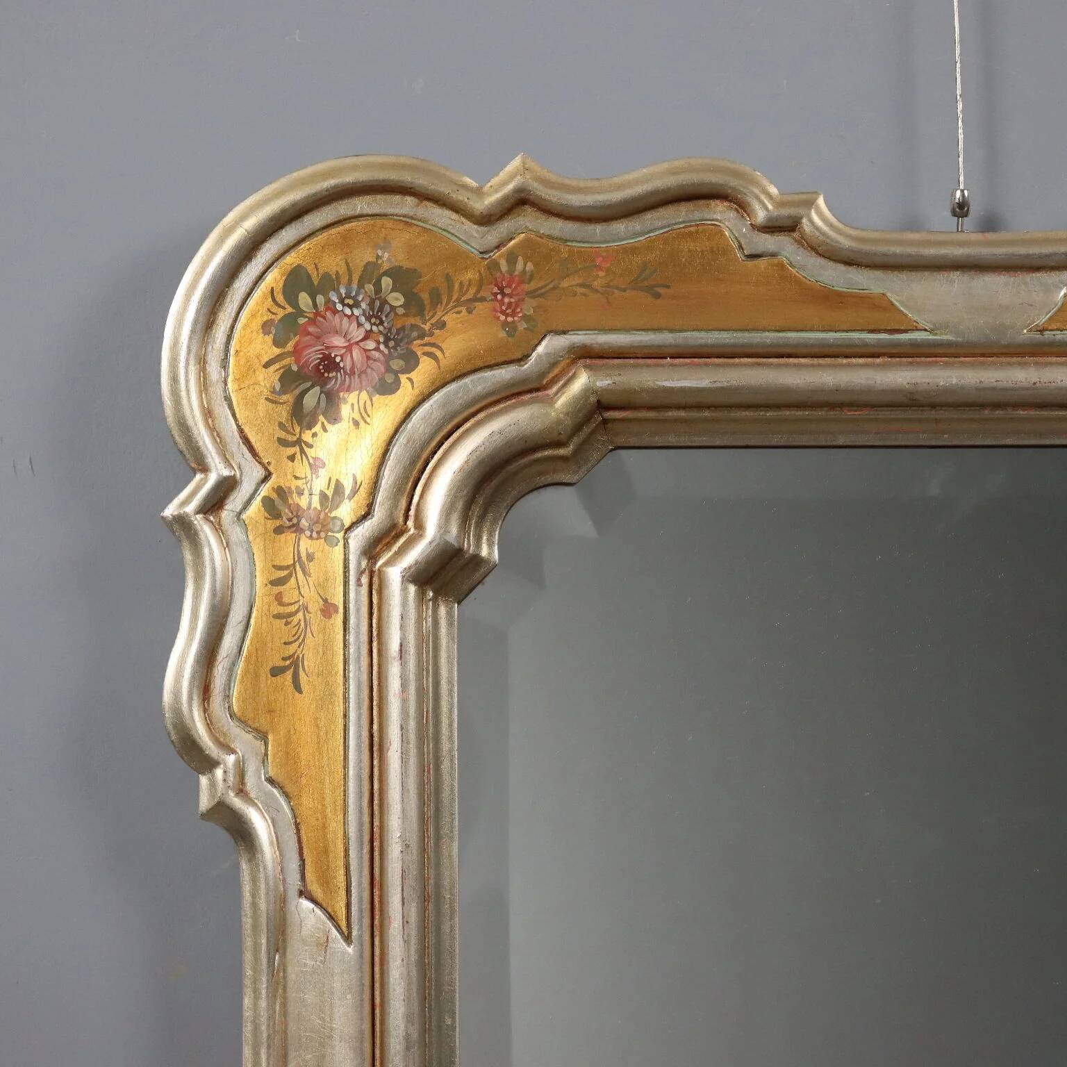 Antique mirror with a gilded frame and floral decorations, Italy, 20th century.