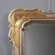 Antique mirror with a gilded frame and floral decorations, Italy, 20th century.