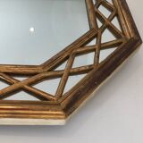 Octagonal mirror in gilded wood with closed guards