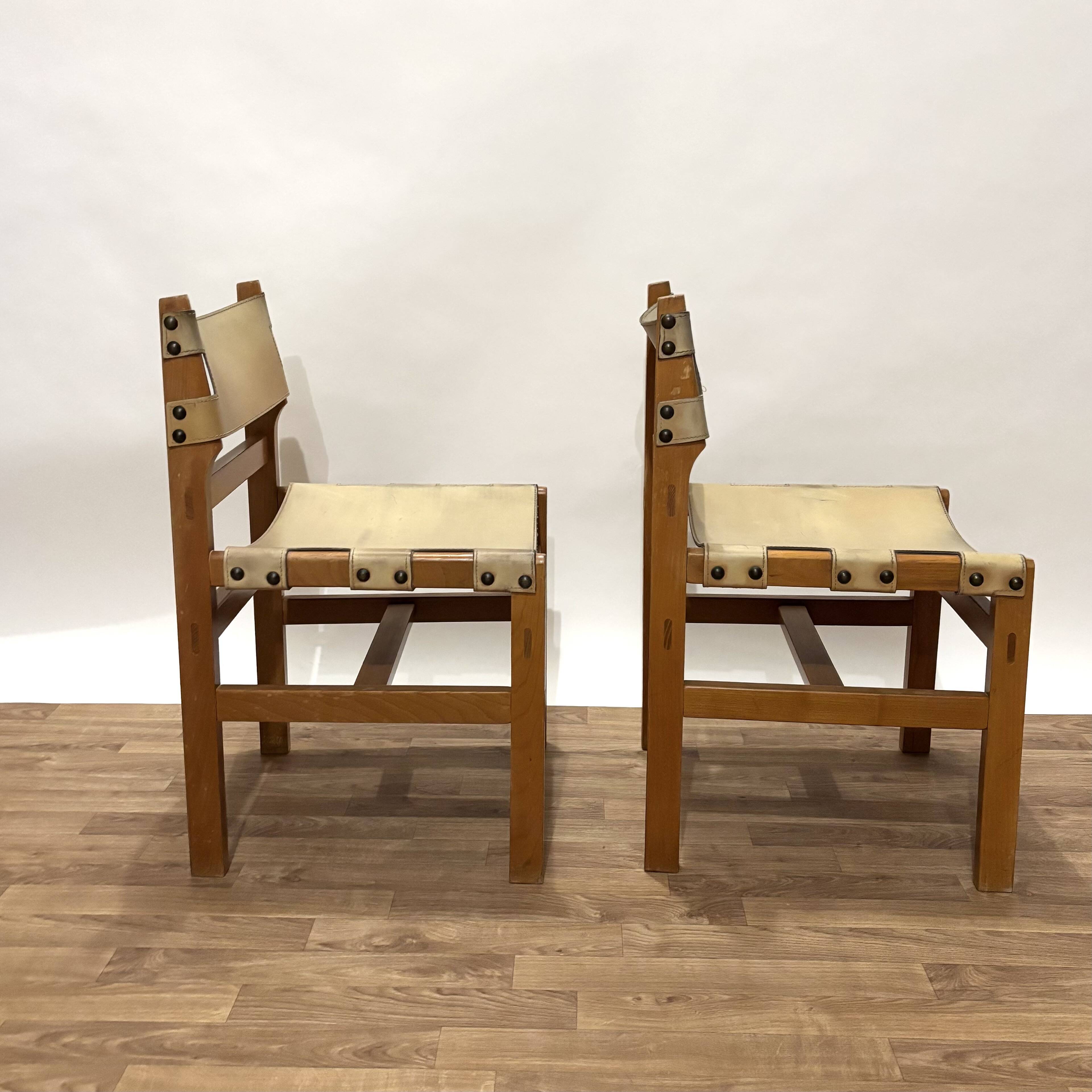 Pair of Maison Regain leather chairs