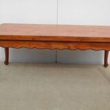 Large solid wood table with integrated extensions.