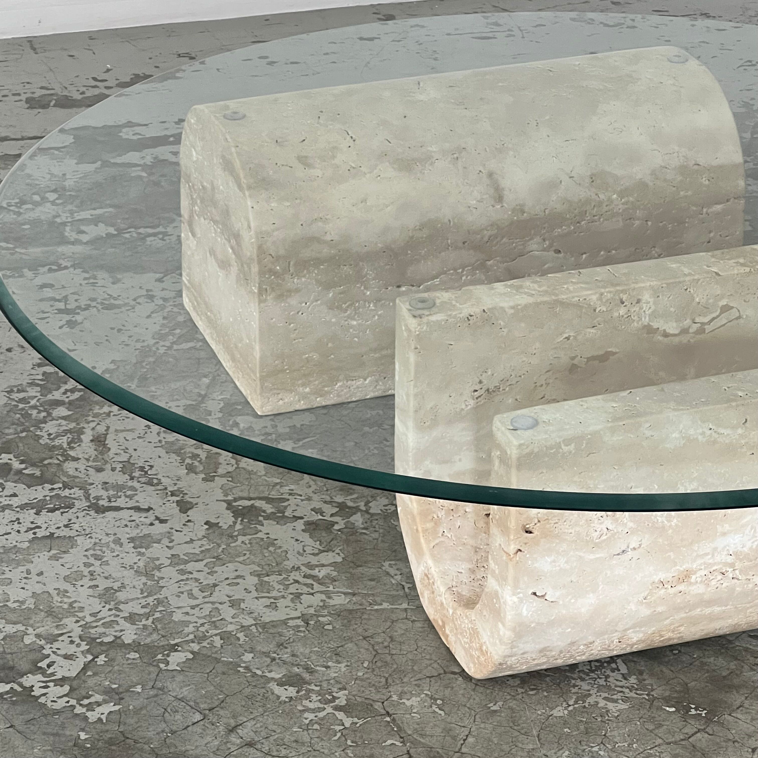 Coffee table in travertine and glass