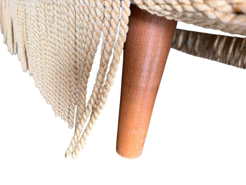 Vintage beige two-seater sofa with fringes