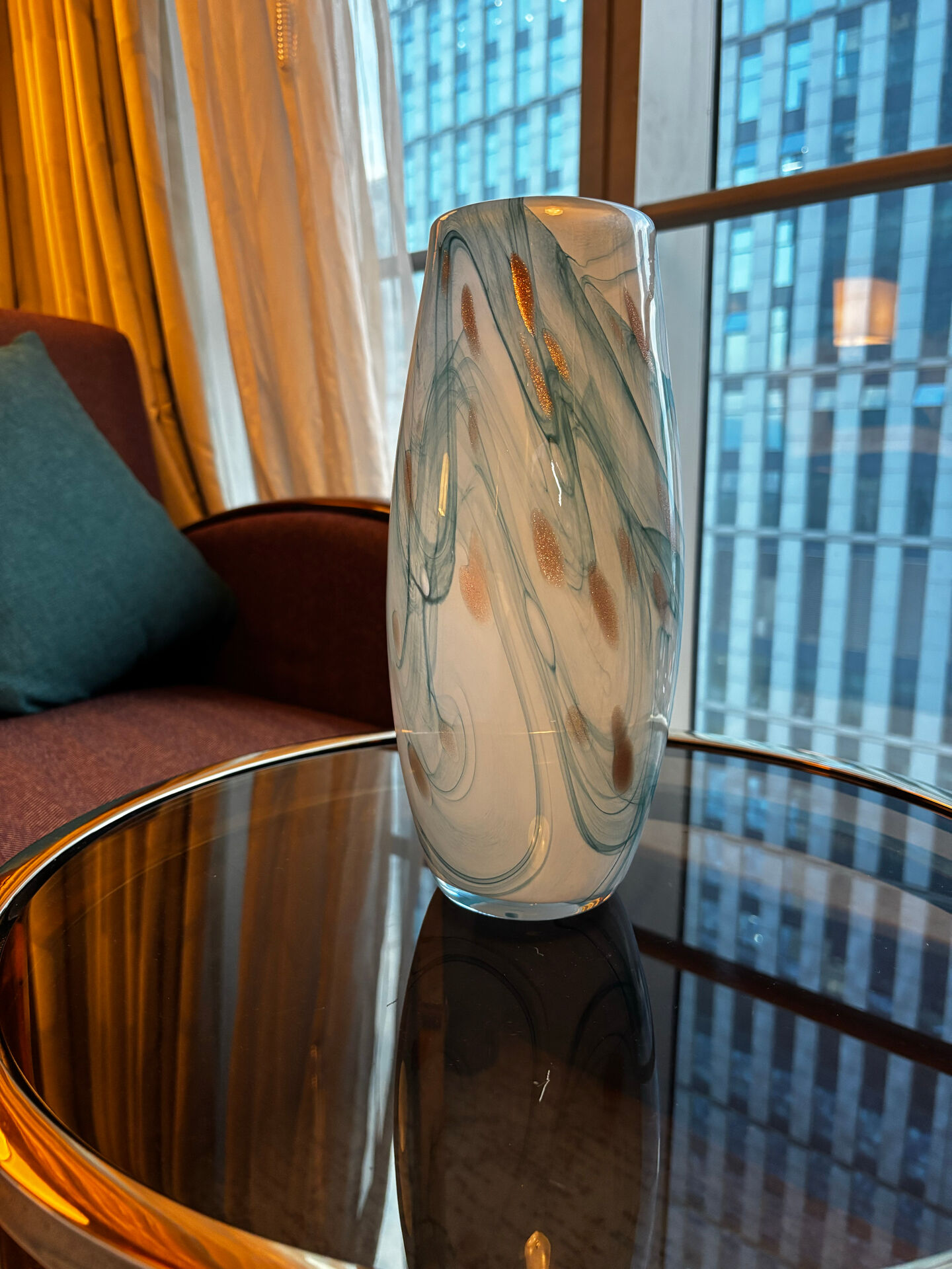 Blown glass vase marbled in white, water green, and with golden inclusions –