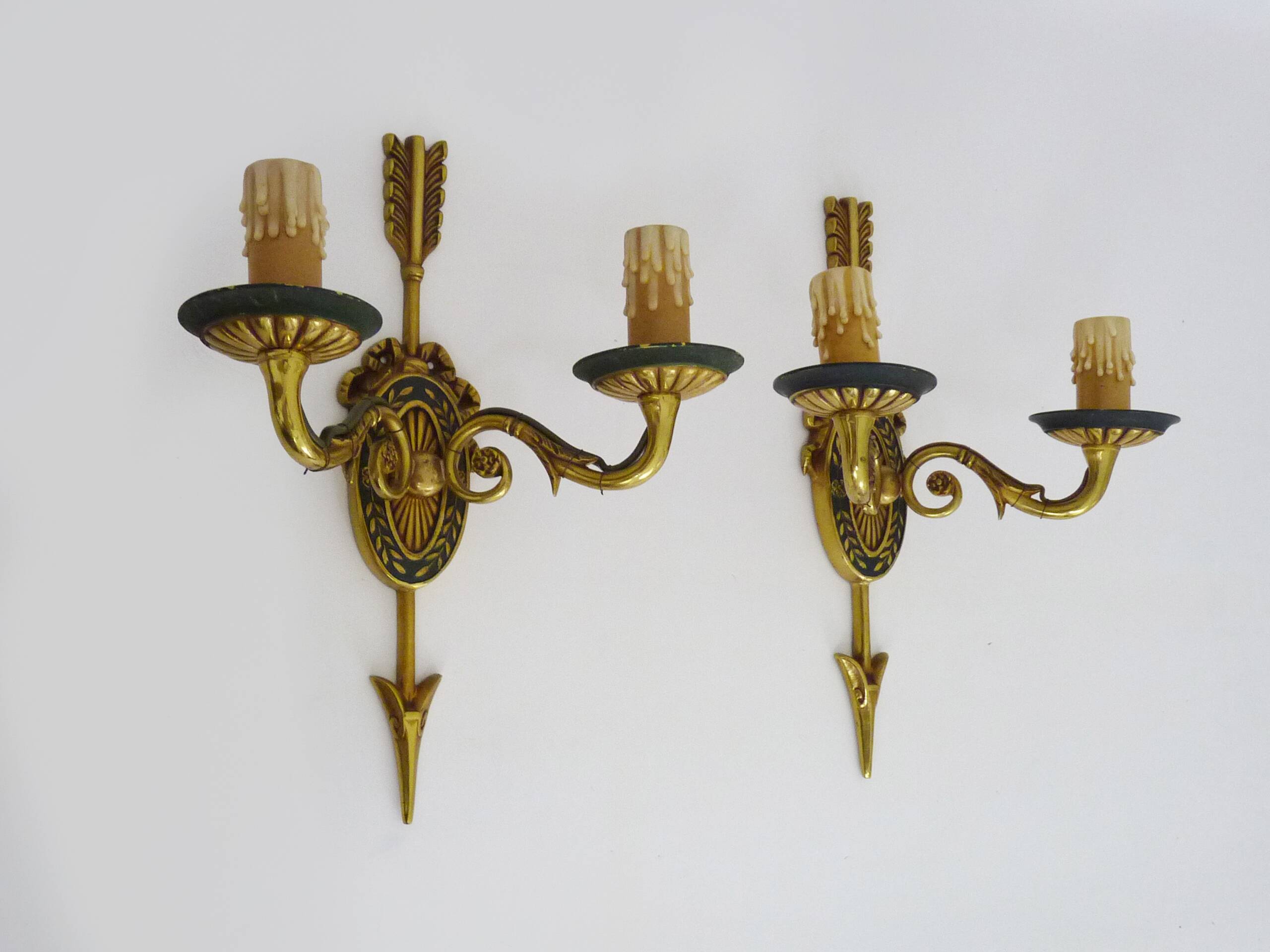 Pair of double-light Empire style arrow wall lights in bronze. Early 20th century