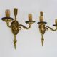 Pair of double-light Empire style arrow wall lights in bronze. Early 20th century