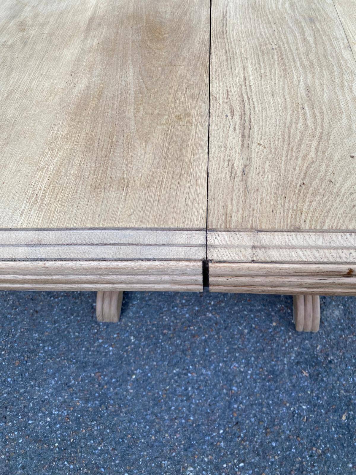 Art Deco dining table with a central pedestal, stripped in solid oak, with 2 extensions.