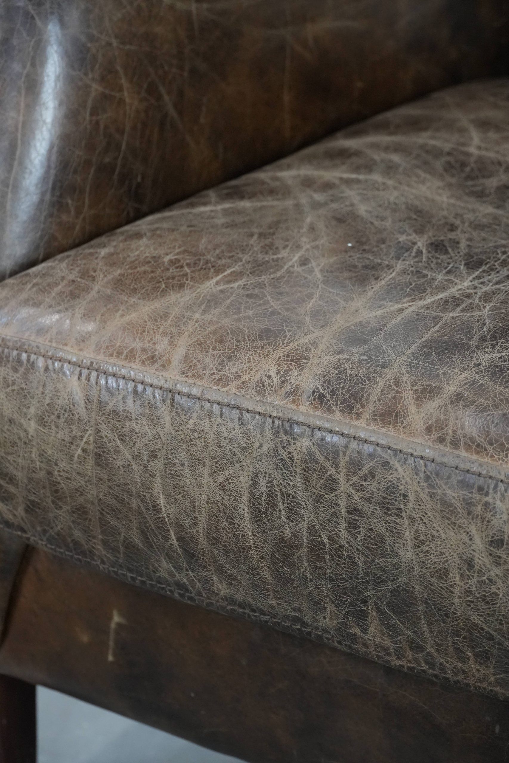 Very comfortable vintage cow leather armchair with character