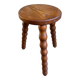 Round tripod stool in dark wood