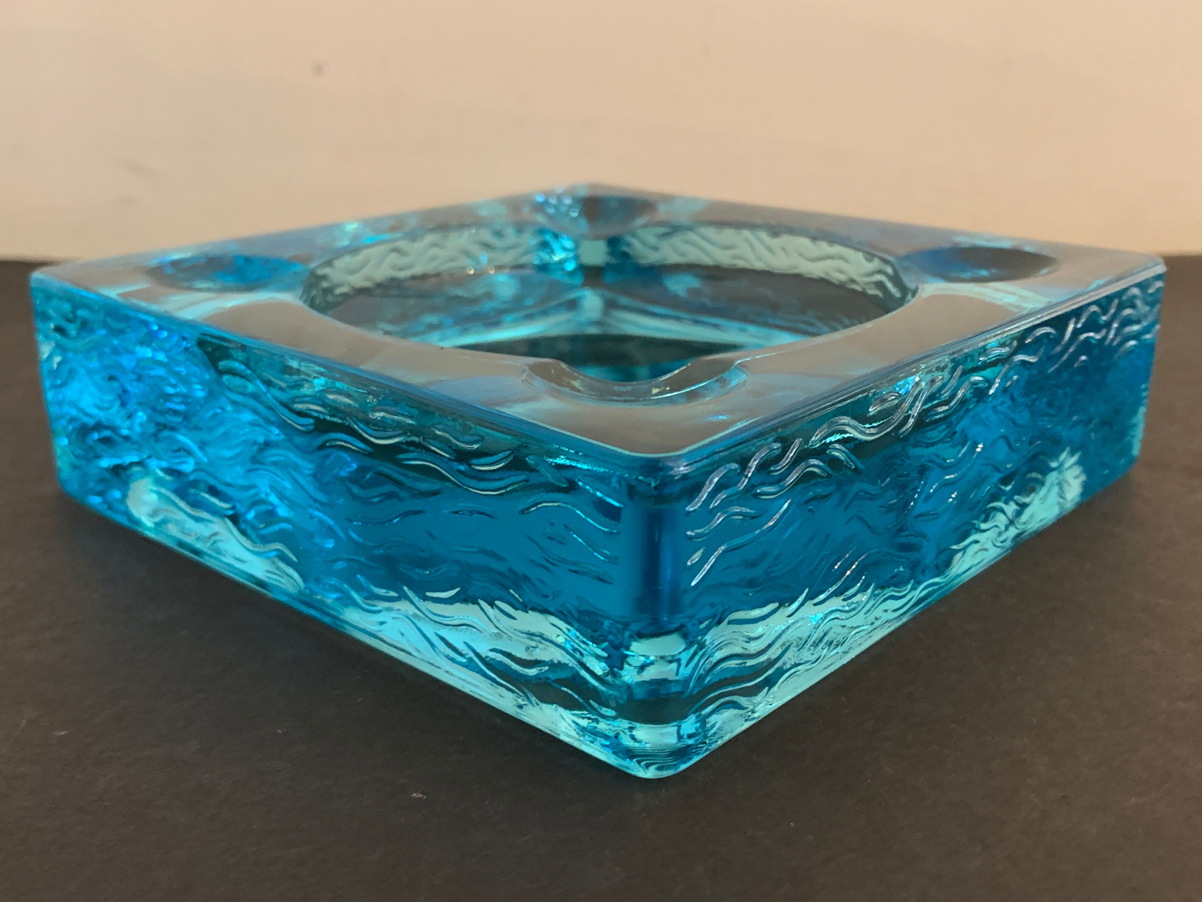 Ashtray paved in blue glass