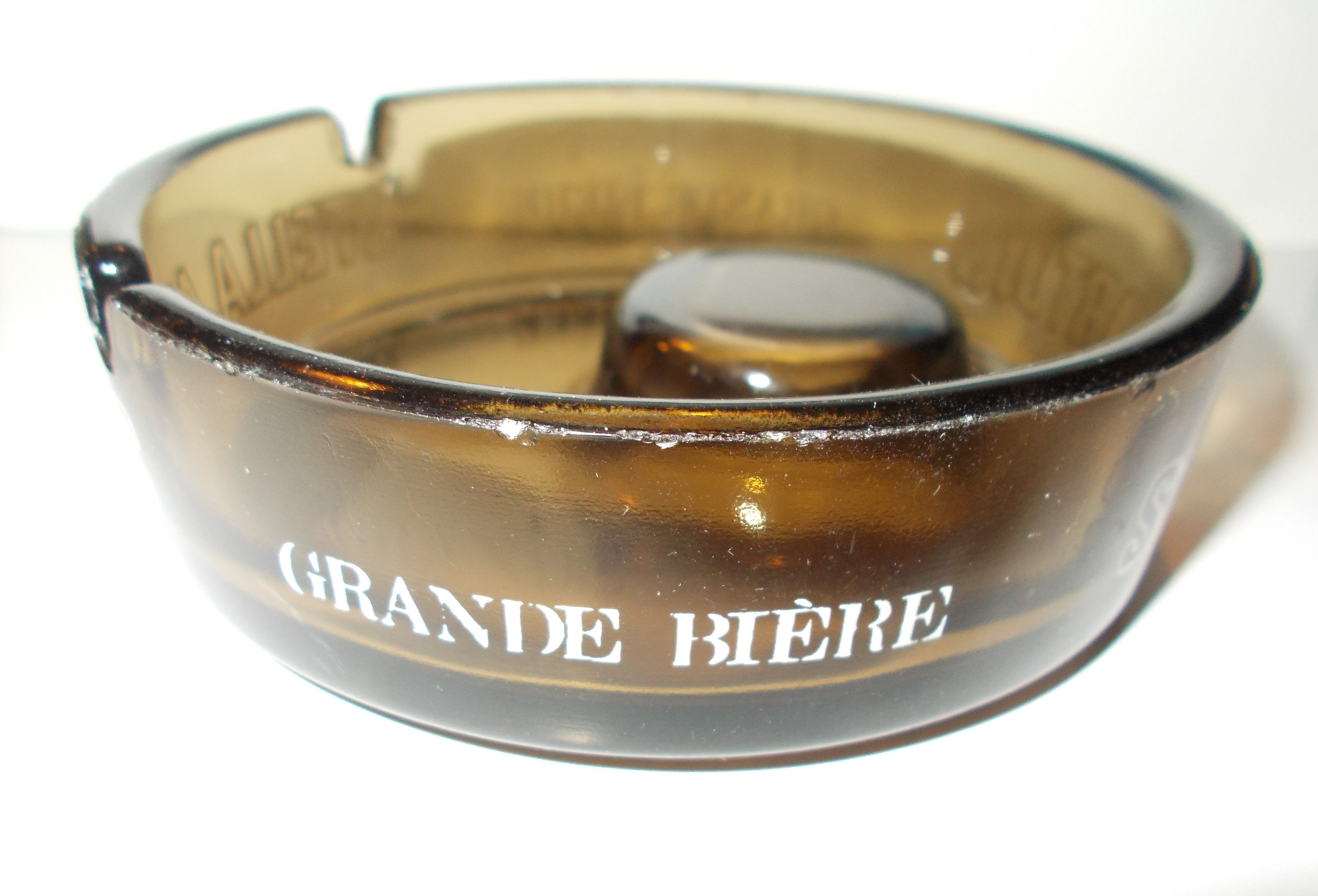 Stella Artois advertising ashtray in smoked glass color