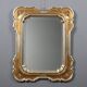 Antique mirror with a gilded frame and floral decorations, Italy, 20th century.