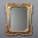 Antique mirror with a gilded frame and floral decorations, Italy, 20th century.