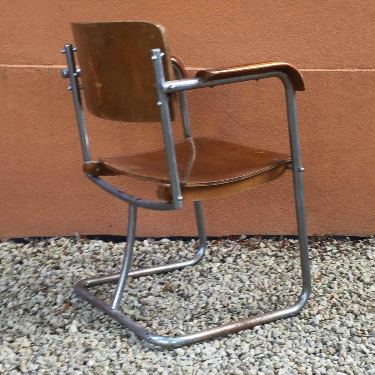 Modernist armchair in plywood, screwed steel tubes