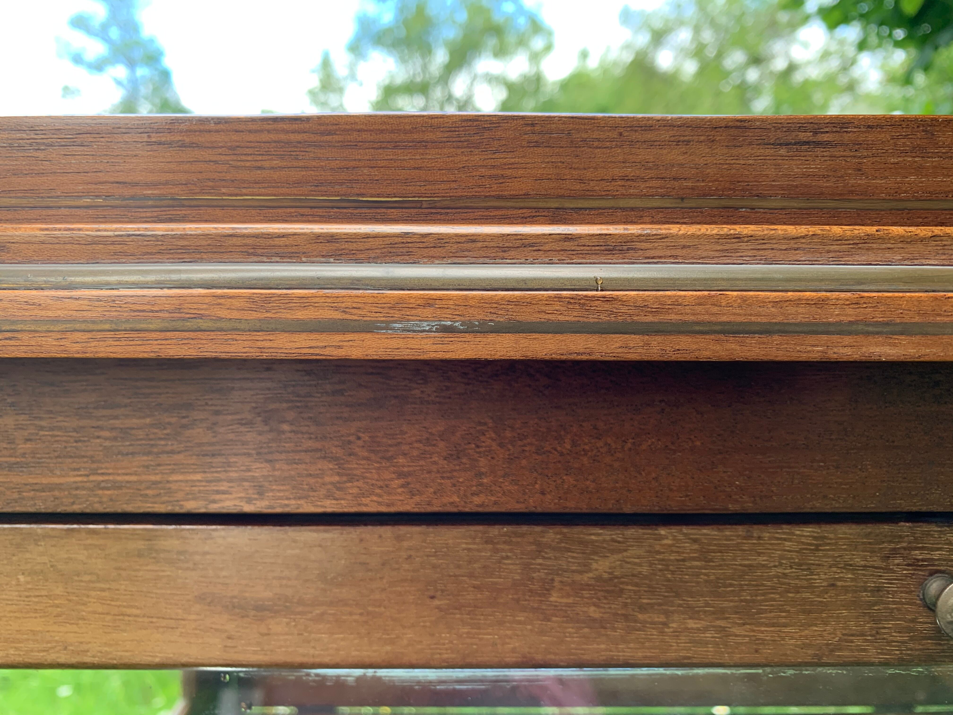 Glass-enclosed old tea table with wooden tray, bronze and brass