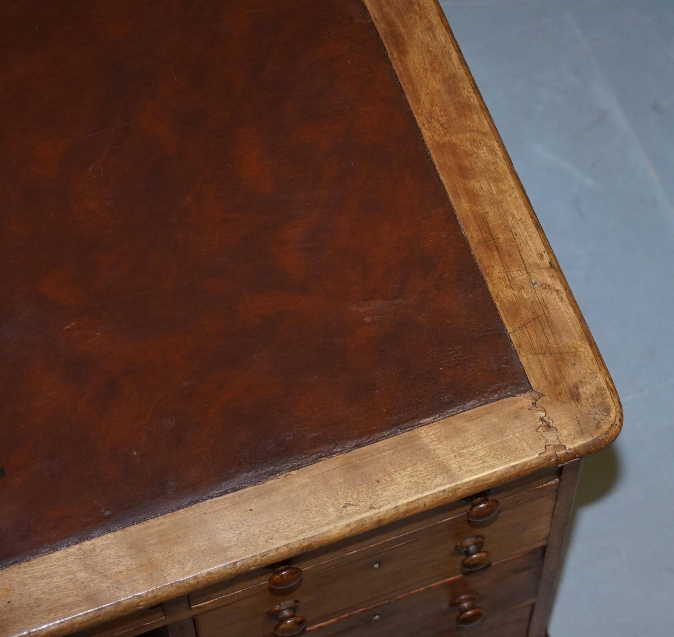 Antique Victorian oak kneehole desk with 18 double-sided drawers.