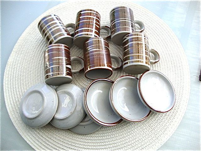 6 coffee cups and sandstone subcups