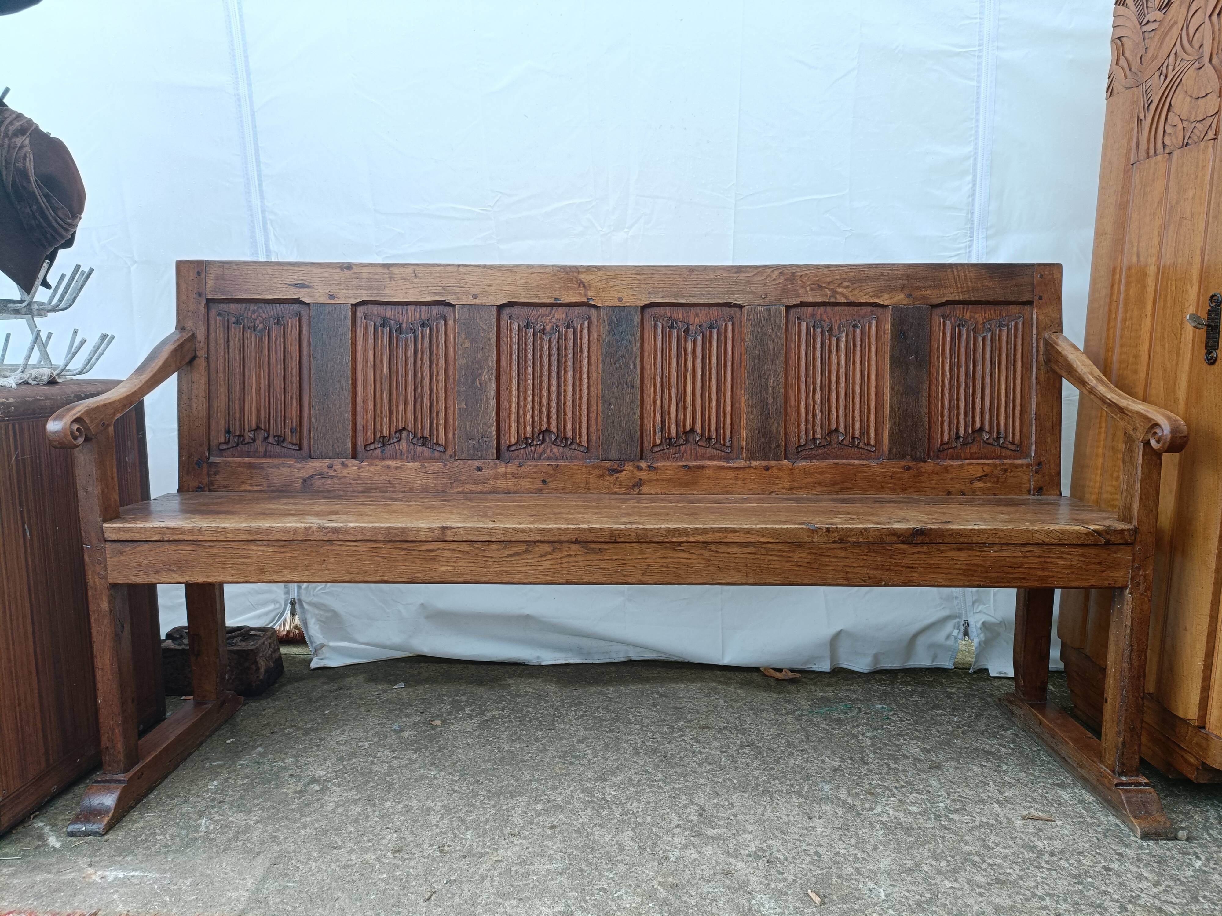 Oak church bench period XVII th century, back decorated with carved parchments