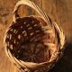 Round woven dark wicker basket with openwork vintage handle