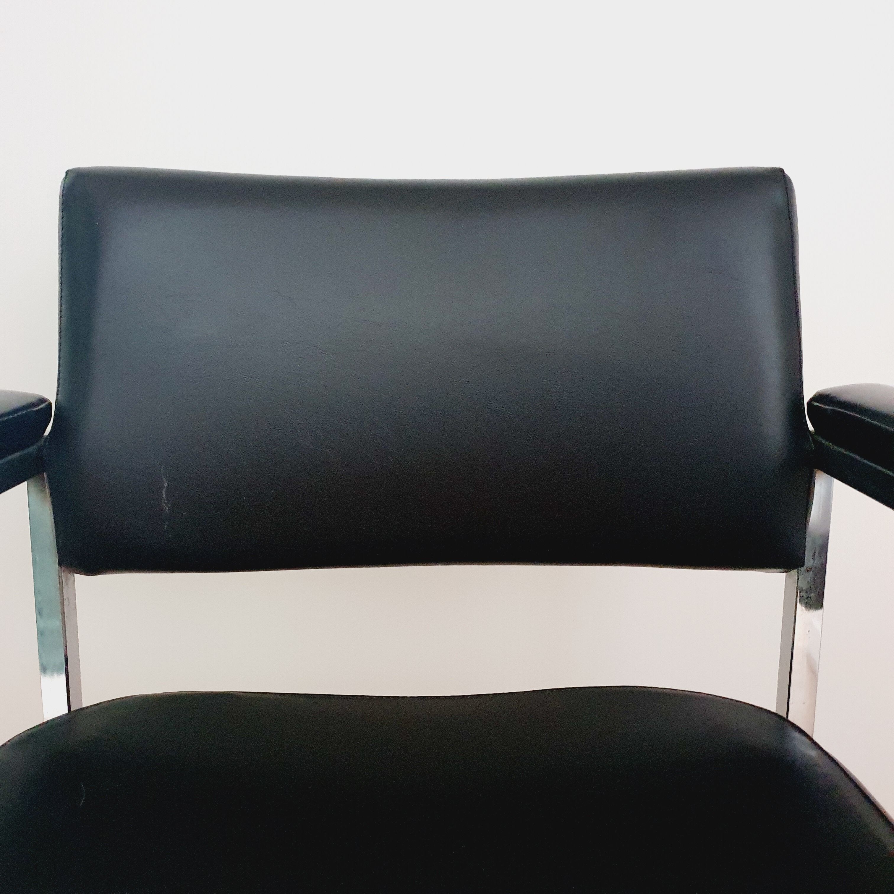 Pair of black skaï and chrome armchairs