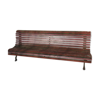 Public bench in wooden slats and cast iron legs
