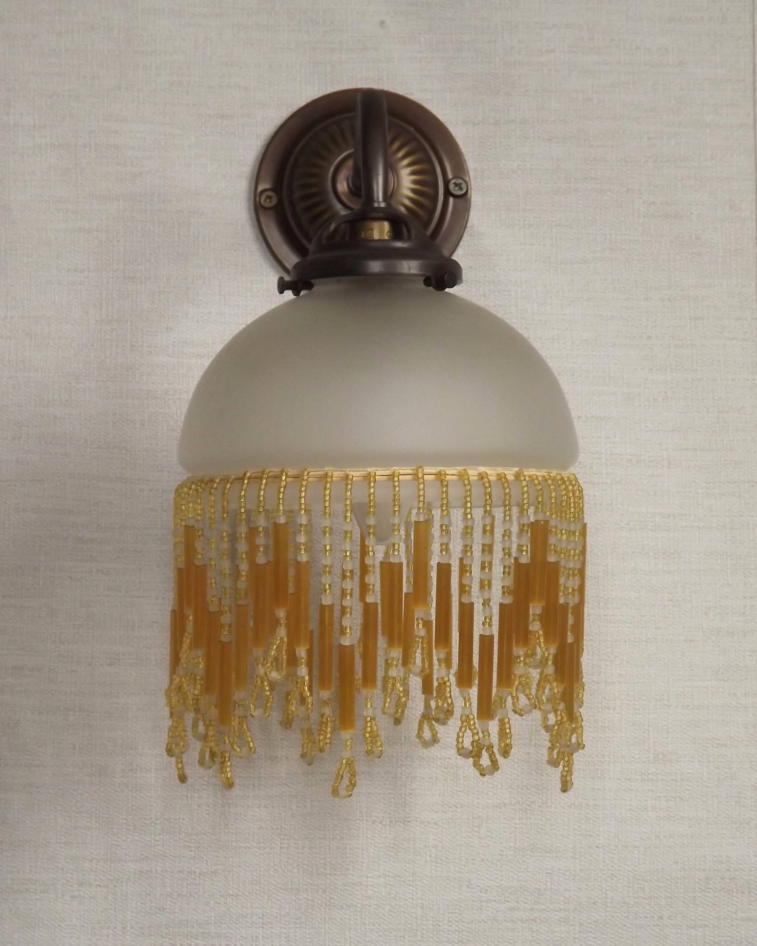 French vintage bronze effect single wall light with opaque beaded glass shade.