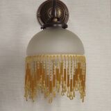 French vintage bronze effect single wall light with opaque beaded glass shade.