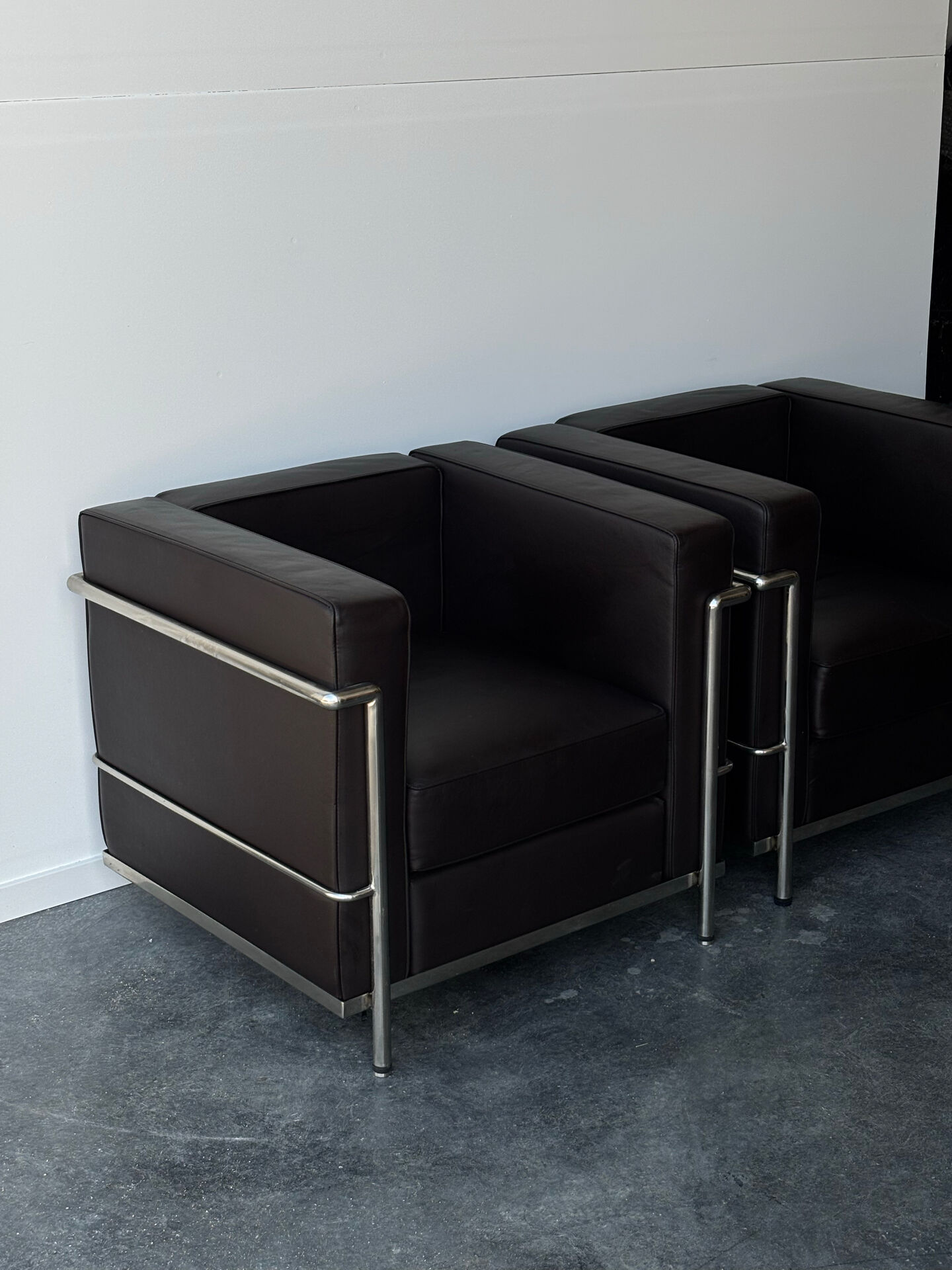 Pair of modernist brown leather armchairs