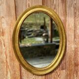 Antique gilded oval mirror