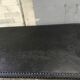 large industrial table in graphite black riveted metal
