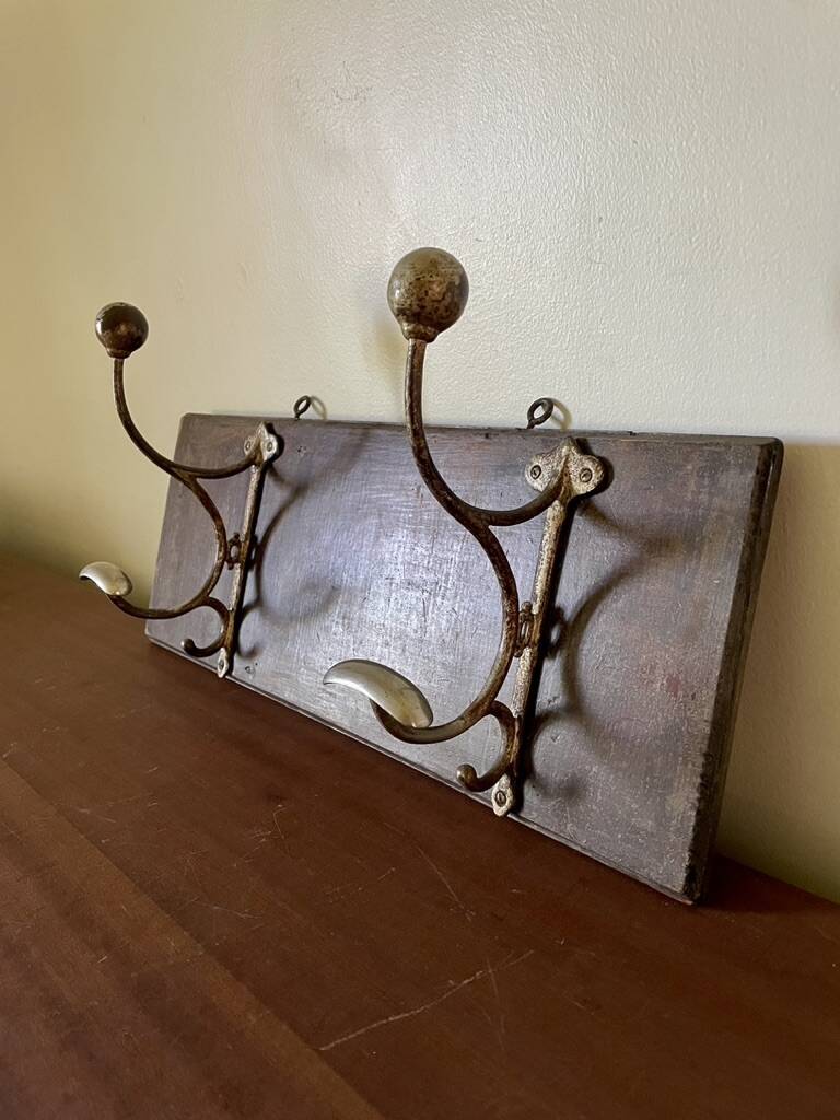 Patinated wood and metal coat rack from the 1950s.