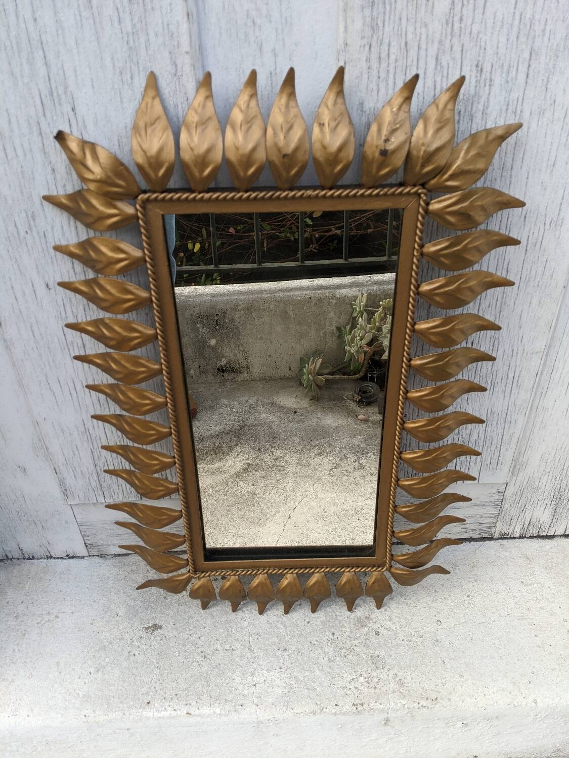 Vintage gold metal mirror with leaves from the 1950s.