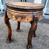 Old wooden saddle pedestal table with claw feet
