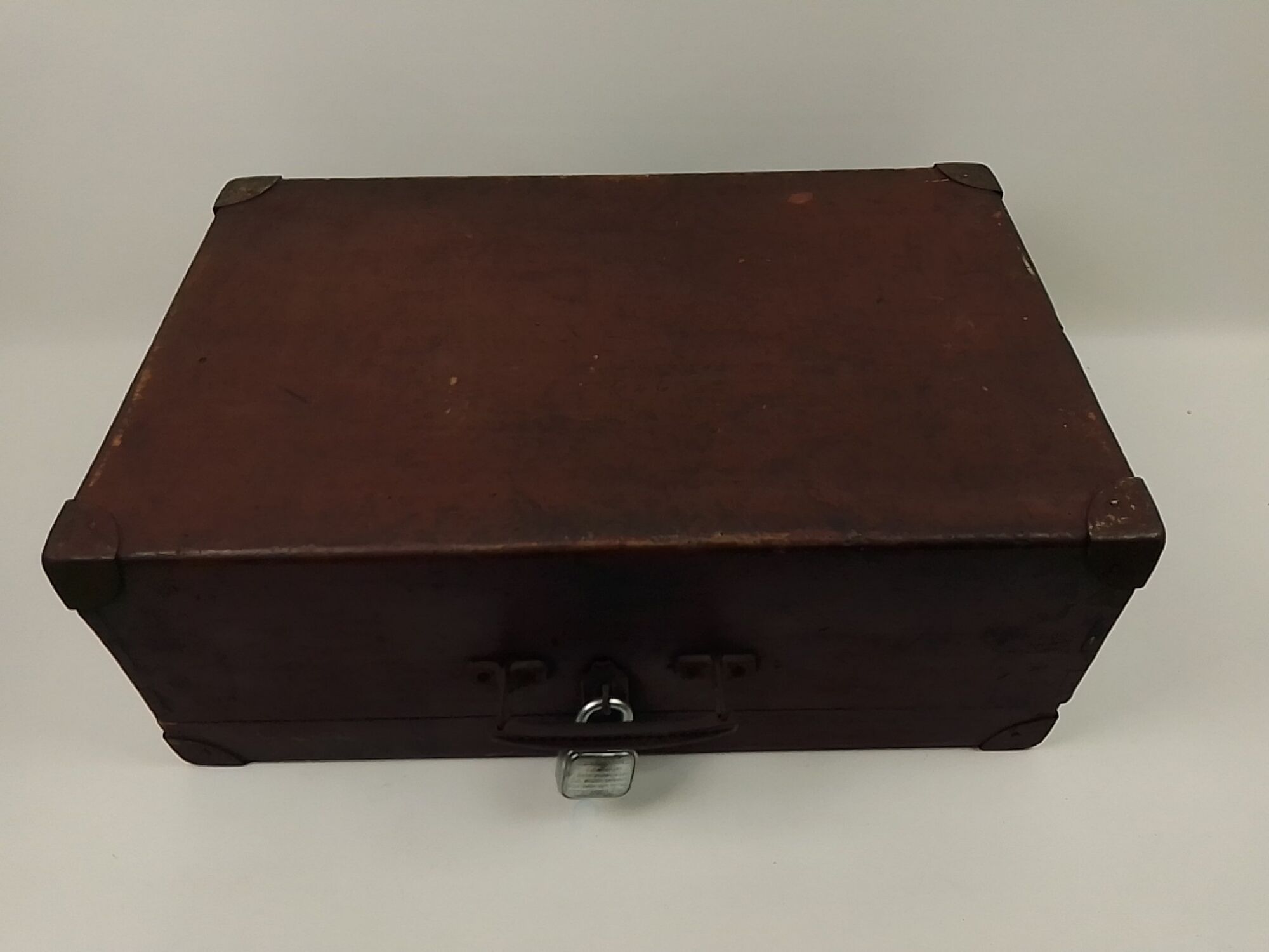 Old wooden suitcase with a padlock