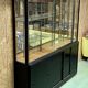 Store window with sliding doors in matte black patinated oak - 30s