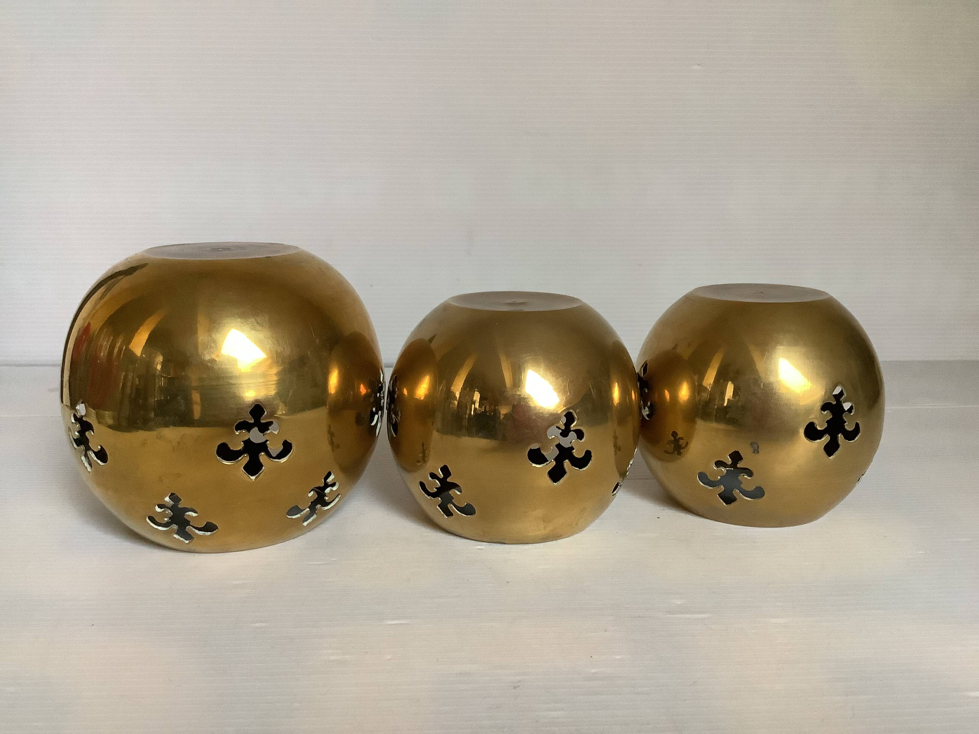 Trio of brass fleur-de-lis candle holders