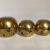 Trio of brass fleur-de-lis candle holders