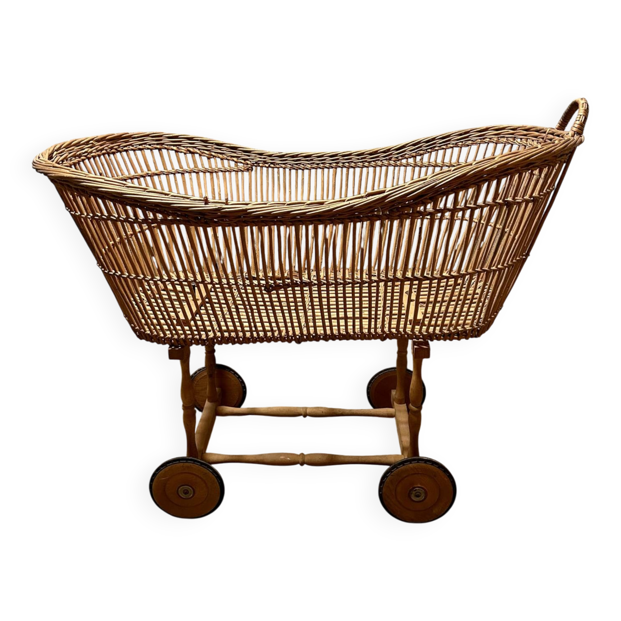 Vintage wicker cradle on wheels