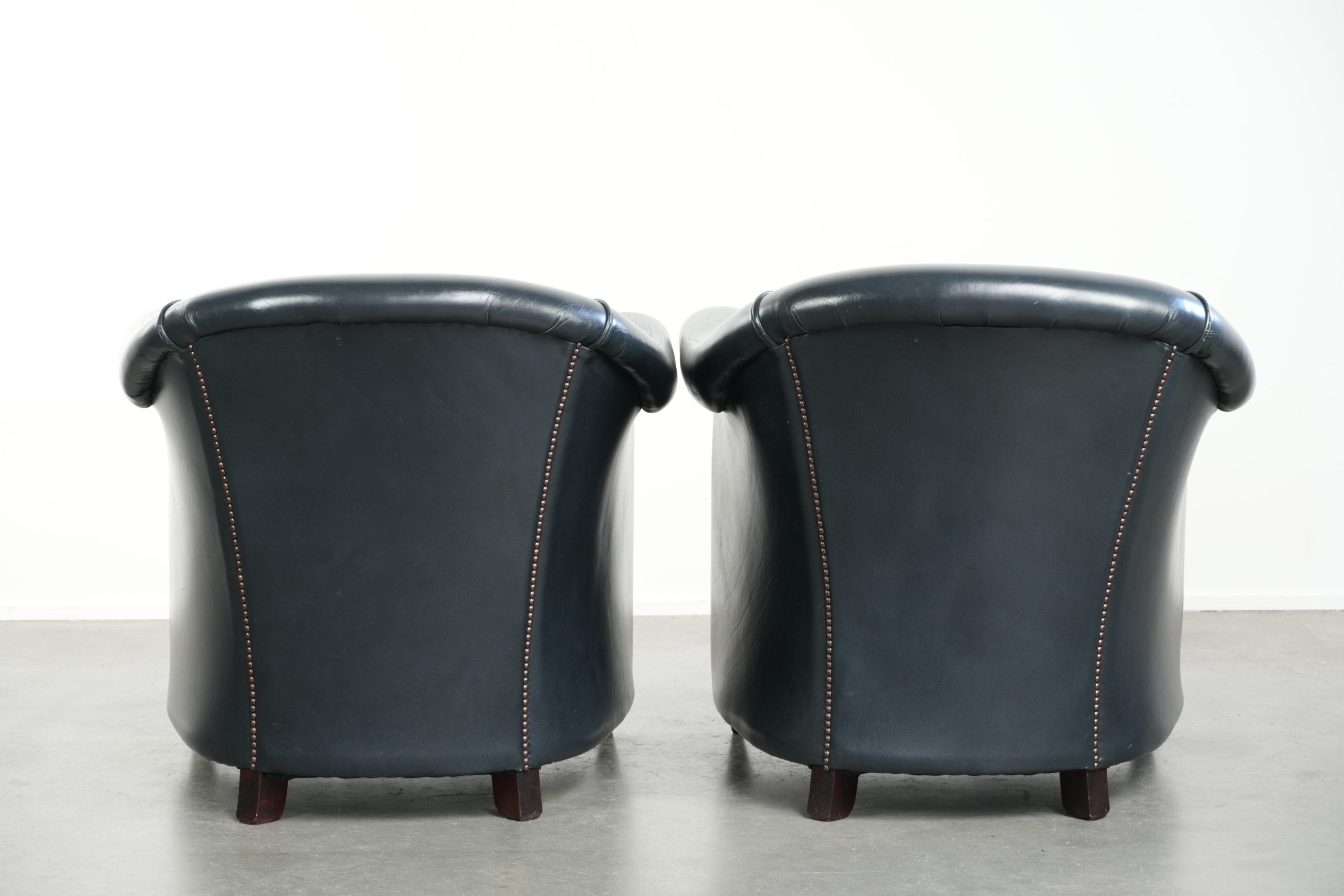 Set of dark blue cow leather club armchairs with a unique design