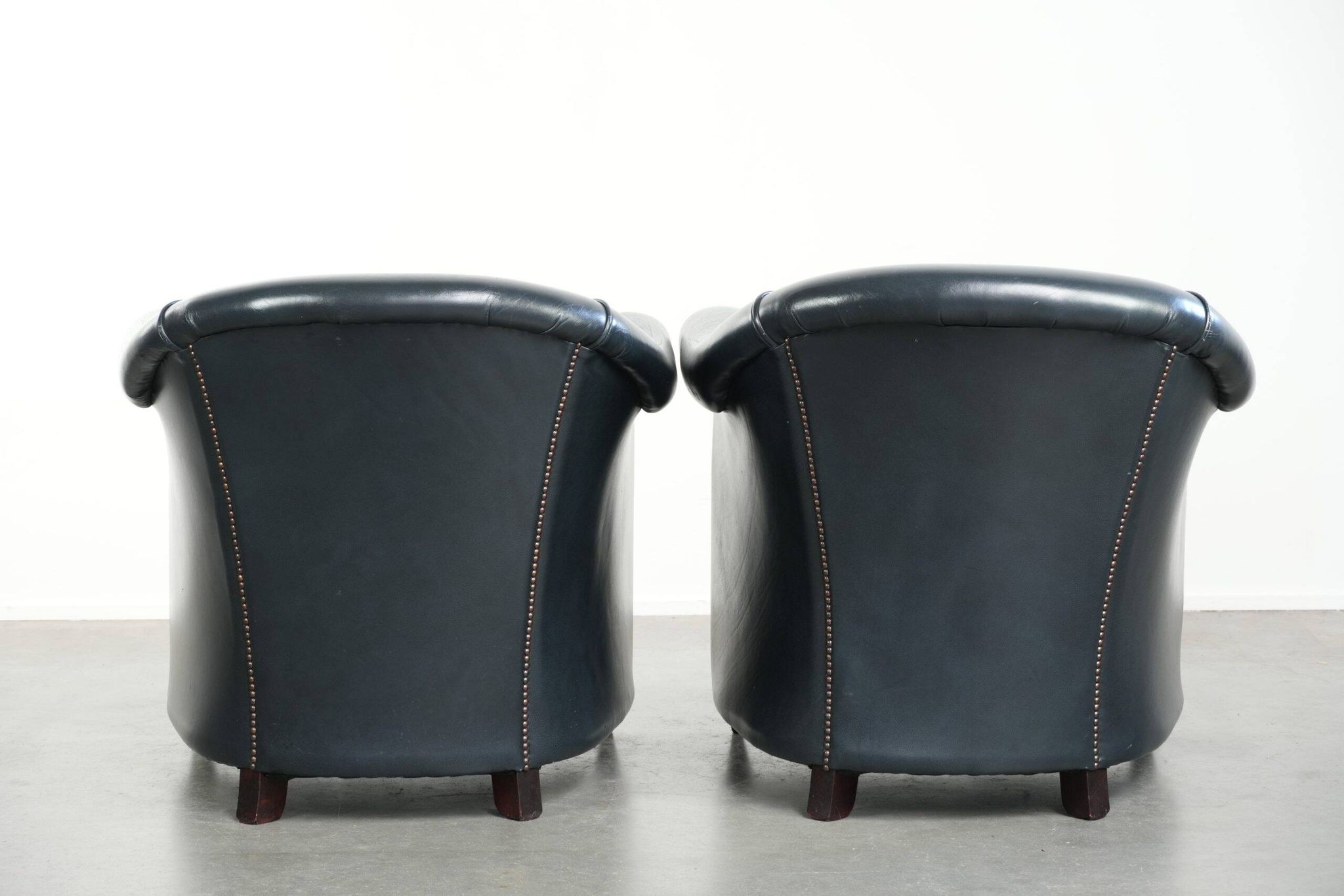 Set of dark blue cow leather club armchairs with a unique design