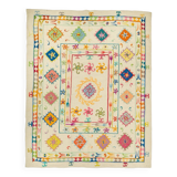 White suzani kilim rug with multi-colored embroidered patterns