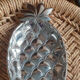 Silver-plated metal tray in the shape of a pineapple.