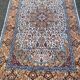 Handmade Persian rug in blue, beige, burgundy, and orange, 95x160cm.