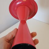 Vintage design candlestick in red metal in the shape of an hourglass