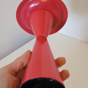 Vintage design candlestick in red metal in the shape of an hourglass