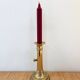 Old brass candlestick with push button.