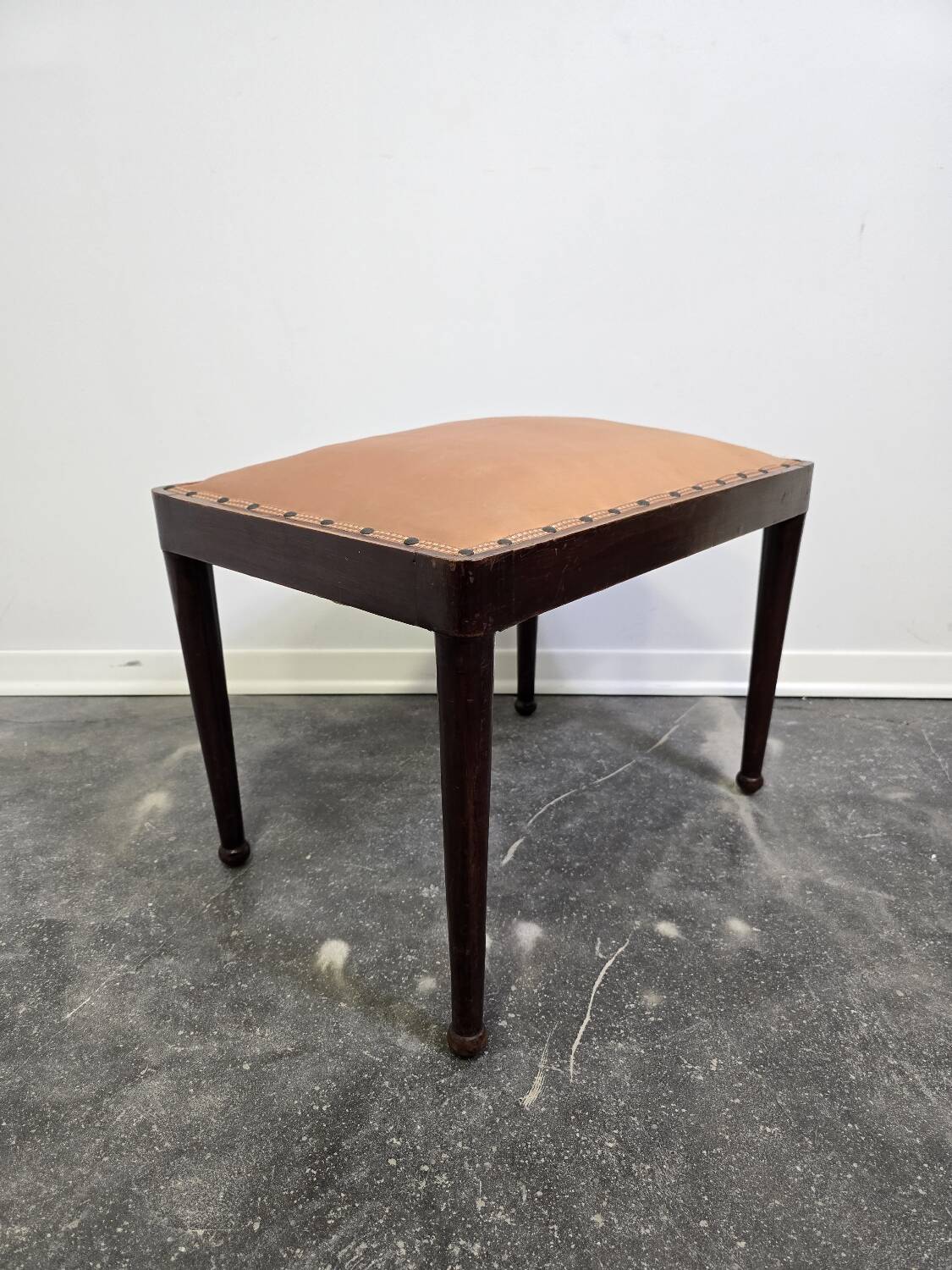 Vintage wooden ottoman from the 1940s with a silk top and studded trim.
