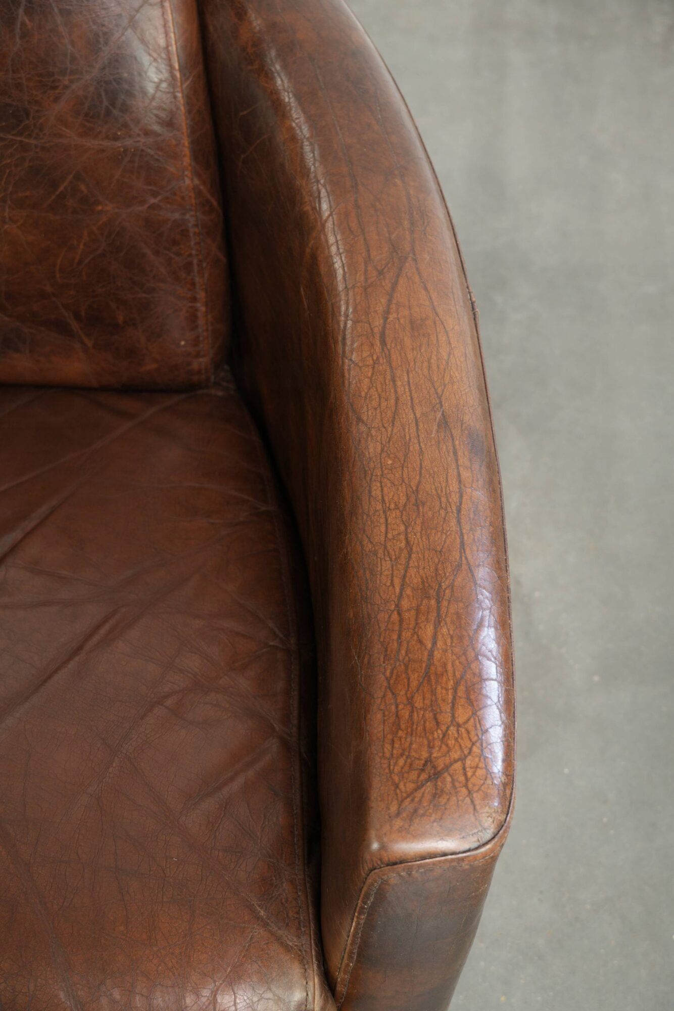 Cowhide armchair in Aviator design in a warm brown colour